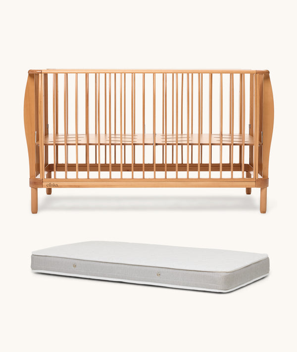 Wooden cot and mattress on a white background