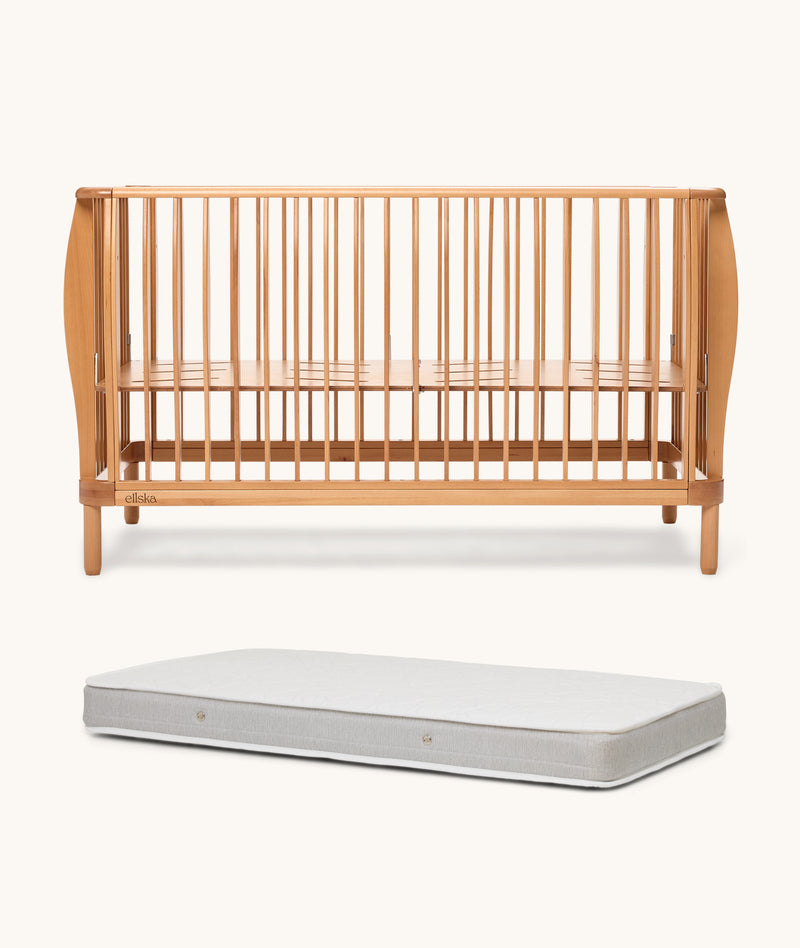 Wooden cot and mattress on a white background