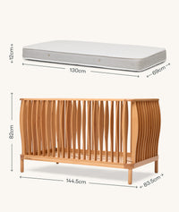 Wooden cot with mattress and dimensions labeled on a white background