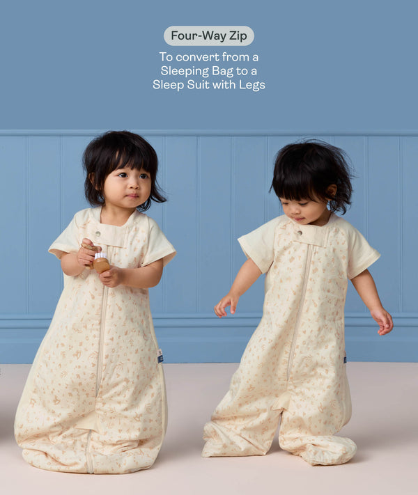 Toddler wearing cream convertible sleep suit bag, demonstrating the bag mode on the left and separate legs mode on the right.