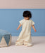 Toddler standing, wearing a 1.0 TOG Sleep Suit Bag featuring short sleeves and a front zip.