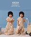Toddler wearing convertible sleep suit bag, demonstrating the bag mode on the left and separate legs mode on the right.