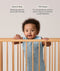 Infant wearing a sleeveless, light blue dragonfly-patterned sleeping bag stands in a wooden cot, holding onto the top rail with both hands. Above the baby, text features highlights for the product: Wash & Wear and TOG-Rated.