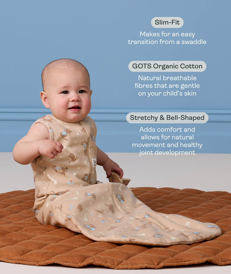 Infant sitting on a brown quilted mat, wearing a sleeveless ergoPouch Sleeping Bag 1.0 TOG with text highlighting 