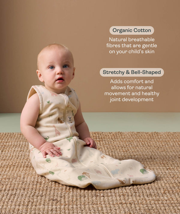 Baby wearing a sleeveless, patterned sleep sack sits on a woven rug, accompanied by product feature callouts for 