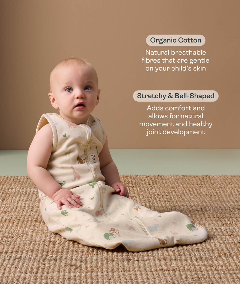 Baby wearing a sleeveless, patterned sleep sack sits on a woven rug, accompanied by product feature callouts for 