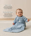 Smiling infant wearing a sleeved Sleeping Bag 1.0 TOG Dragonflies with text highlighting organic cotton and stretchy & bell-shaped design.