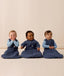 Three infants sitting side by side, wearing ergoPouch Sleeping Bags in 1.0, 2.5 and 3.5 TOGs