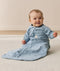 Smiling infant wearing a sleeved Sleeping Bag 1.0 TOG Dragonflies