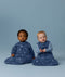 Two infants sitting side by side wearing  Premium Sleeping Bag 3.5 TOG and Jersey Sleeping Bag 2.5 TOG in Starbeam colourway.