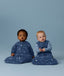 Two infants sitting side by side wearing  Premium Sleeping Bag 3.5 TOG and Jersey Sleeping Bag 2.5 TOG in Starbeam colourway.