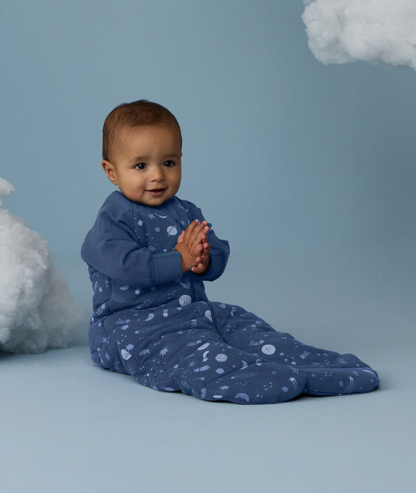Baby wearing an ergoPouch Sleeping Bag 3.5 TOG Sleeved Starbeam