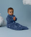 Baby wearing an ergoPouch Sleeping Bag 3.5 TOG Sleeved Starbeam