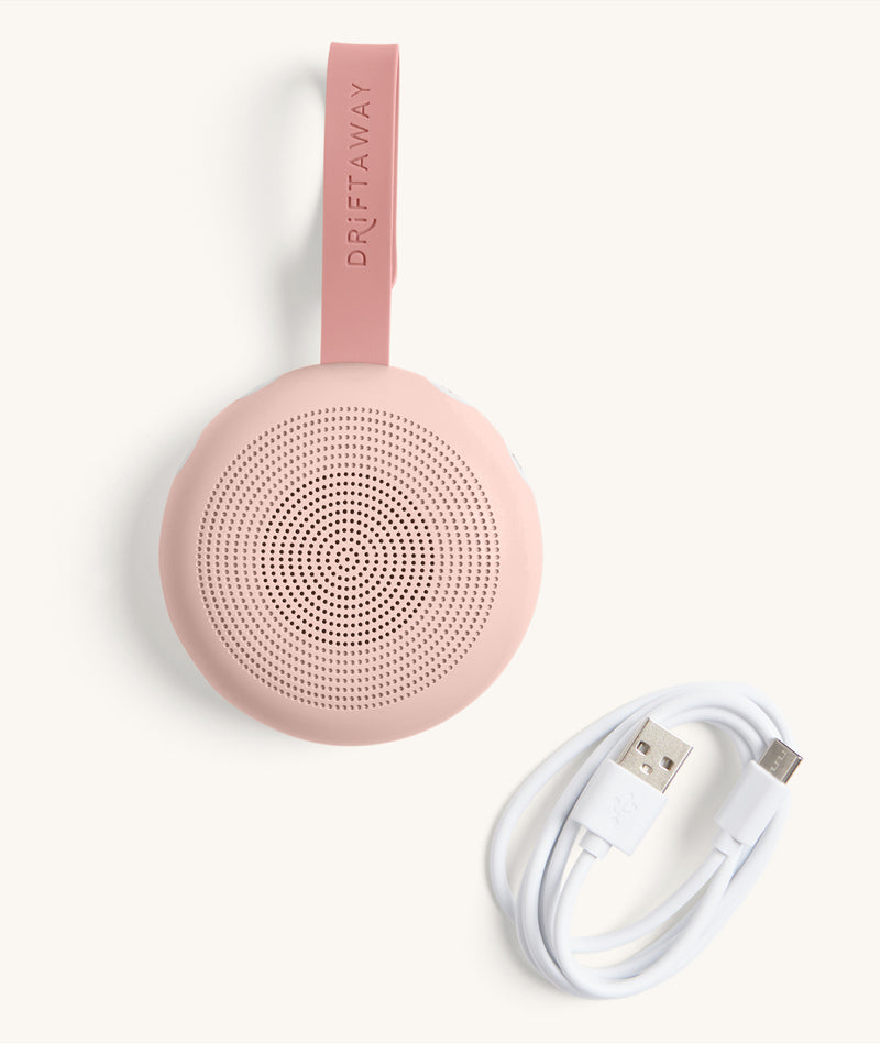 The Drift Away White Noise Machine in Blush with charging cable