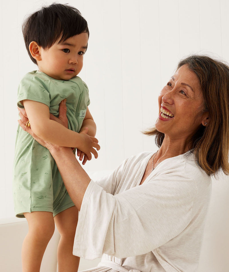 Grandmother wearing Matchy Matchy Robe in Oatmeal Marle smiling, picking up grandchild