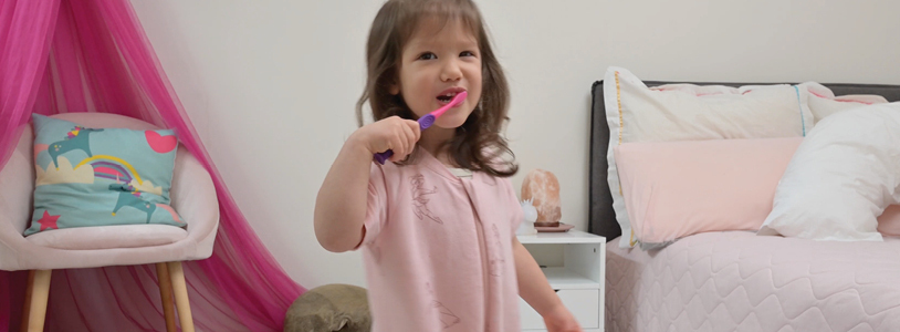Toddler brushing her own teeth