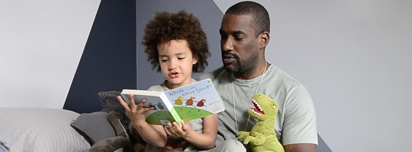 Father reading to his son as part of their bedtime routine