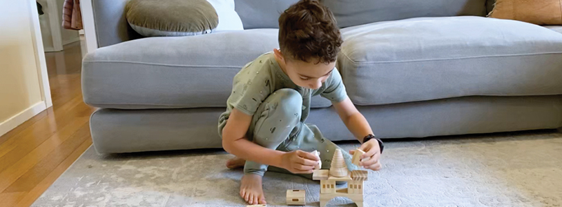 Boy calmly playing with building blocks before bed