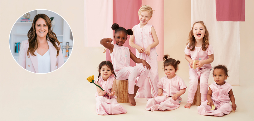 Five toddlers wearing pink ergoPouch sleepwear next to Amanda Abel, paediatric psychologist