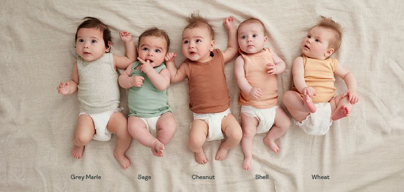 Newborn babies wearing ergoPouch bodysuits