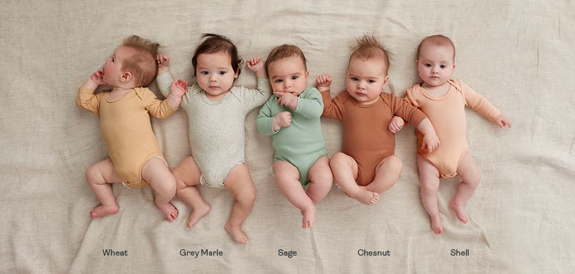 Newborn babies wearing different colours of ergoPouch long sleeve bodysuits