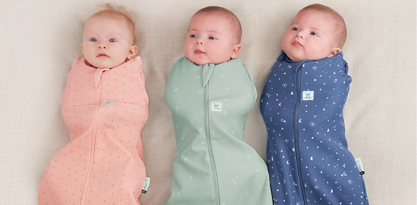 Three swaddled babies laying side by side