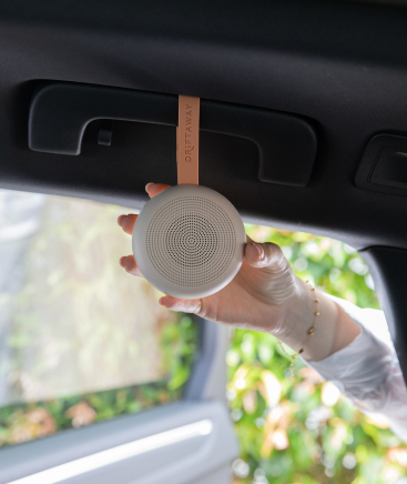 Baby white noise machine hanging from car handle